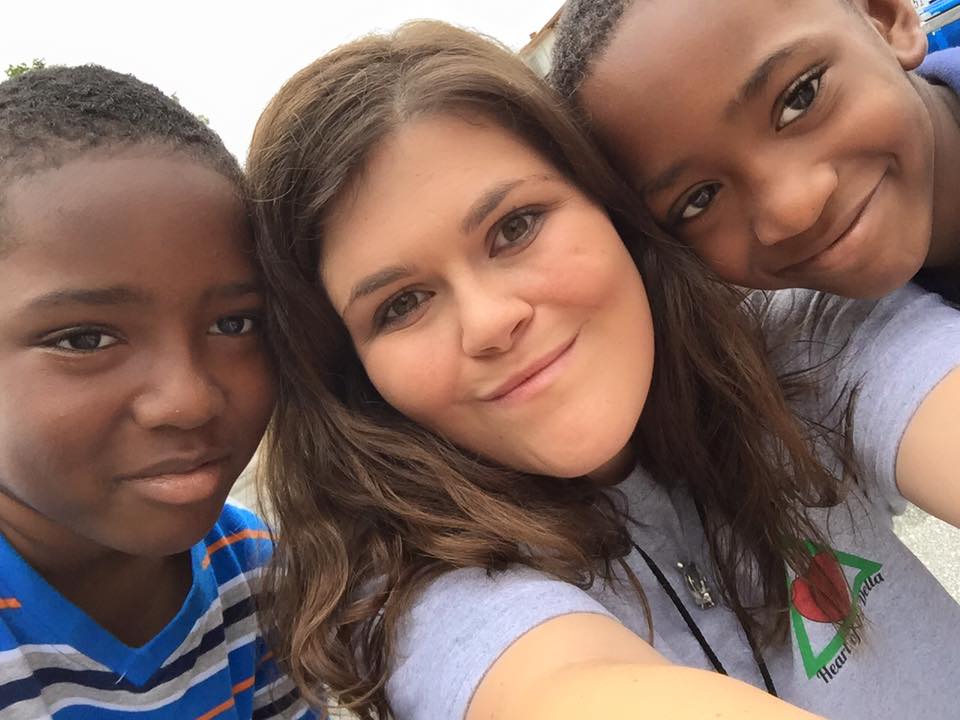 Summer Missionary Robin is pictured here with two children from here ministry. 37 students served with Mission Arlington this summer.