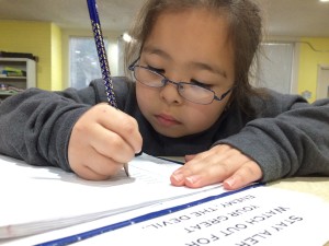 Working on homework and learning God's word is an important part of Mission Arlington's "after-school" programs.