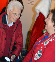 Tillie Burgin Director of Mission Arlington since the beginning, in the Christmas Store talking with a volunteer.